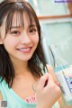 A woman holding a bottle of water in her hand.