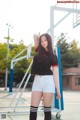 A woman standing on top of a basketball court.