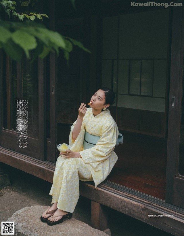 A woman sitting on a bench eating a bowl of food.